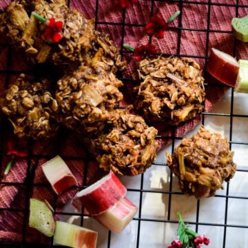 Cookies with oats on cooling rack with rhubarb beside them.