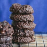 Brownie cookies stacked on a cooling rack.