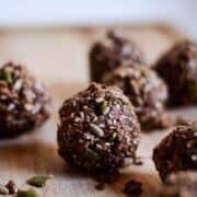 Chocolate flax energy balls on wood plat