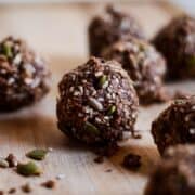 Chocolate flax energy balls on wood platte
