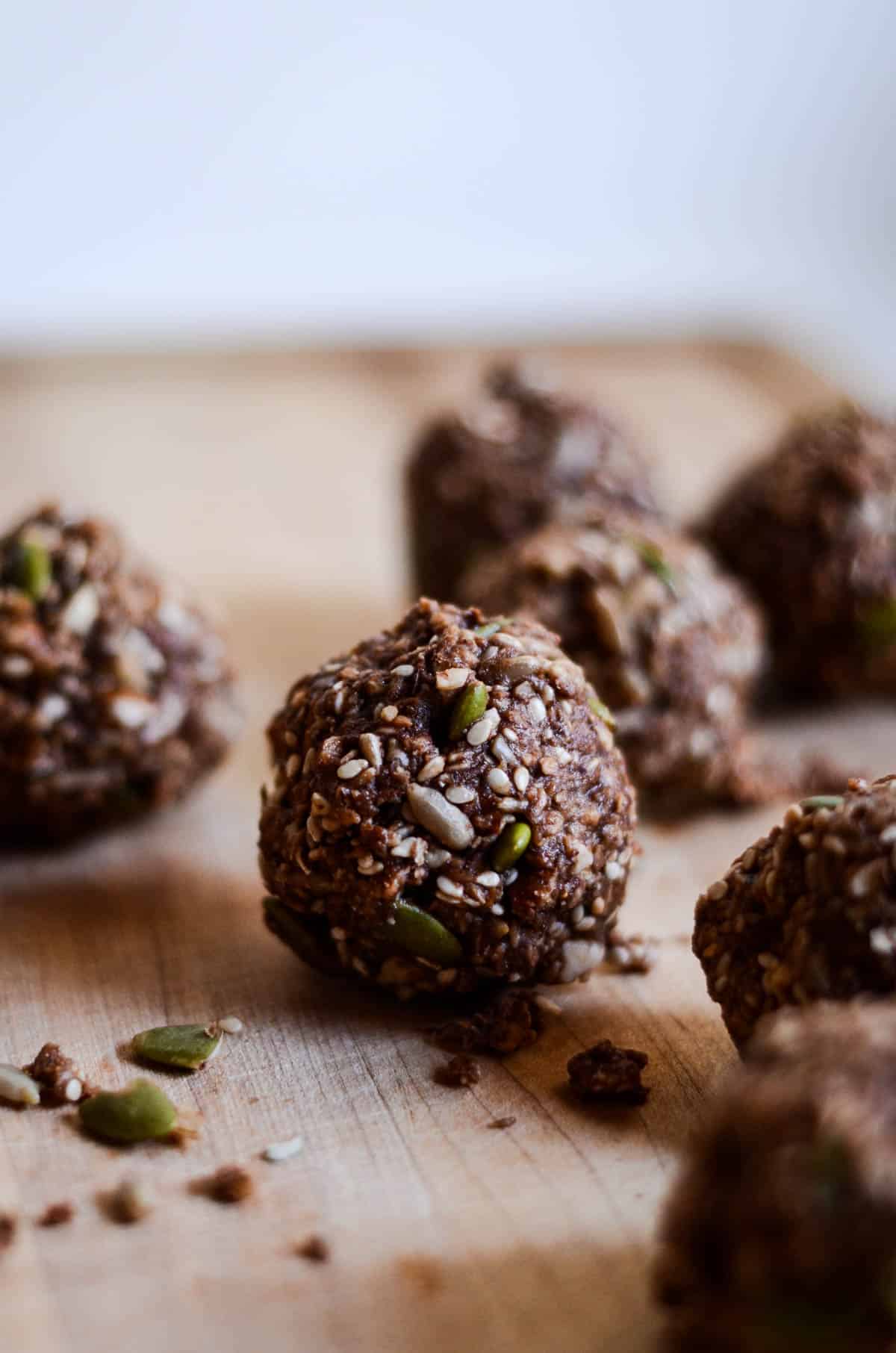 Chocolate energy balls on wood platter.