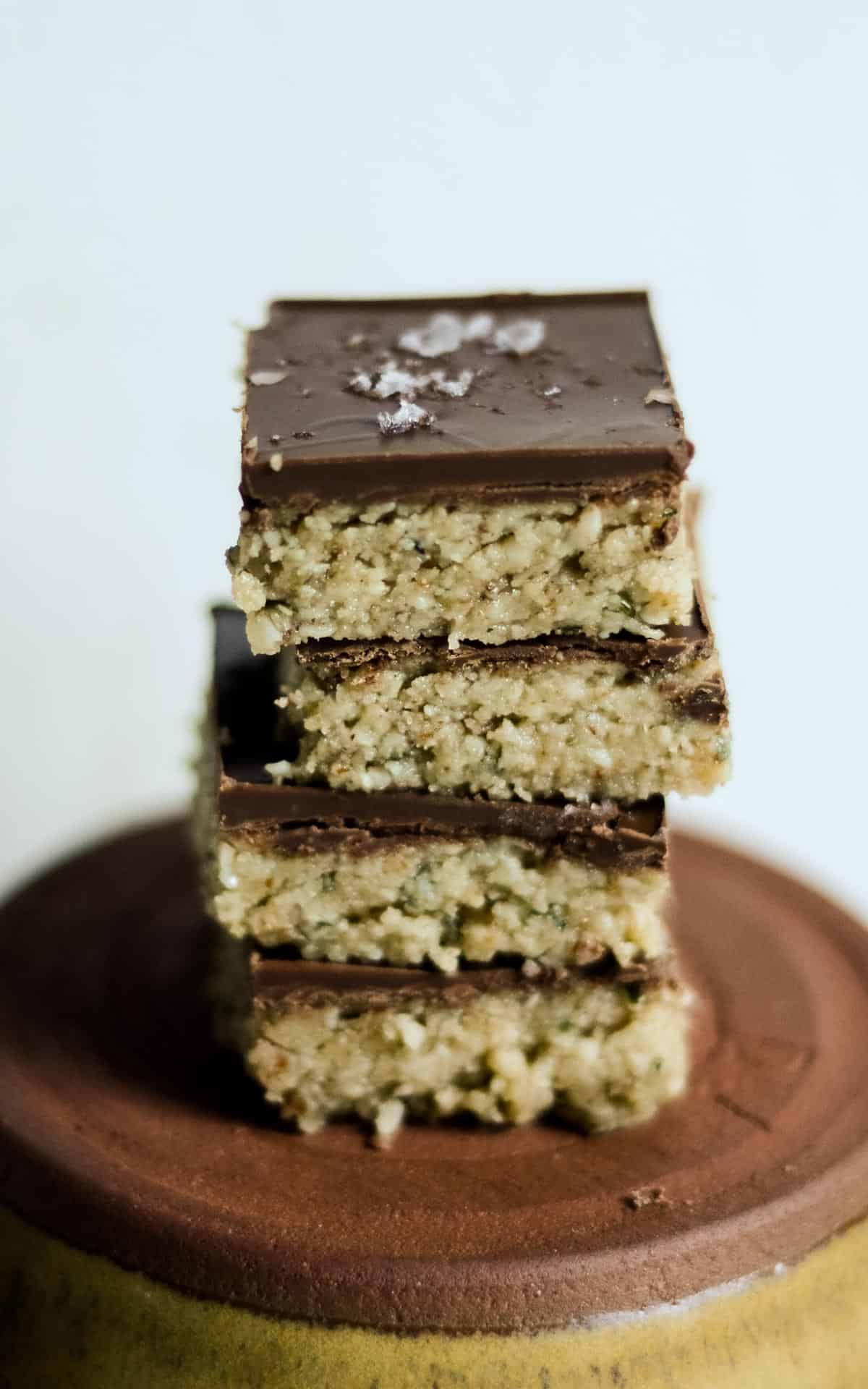 4 stacked no bake protein bars with almond butter.