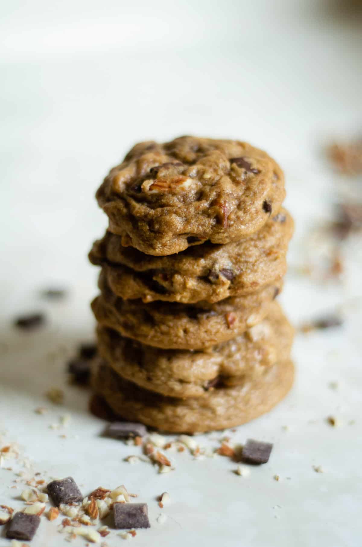5 olive oil cookies stacked, showing chocolate and almonds.