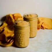 Two pineapple quinoa smoothies in jars.