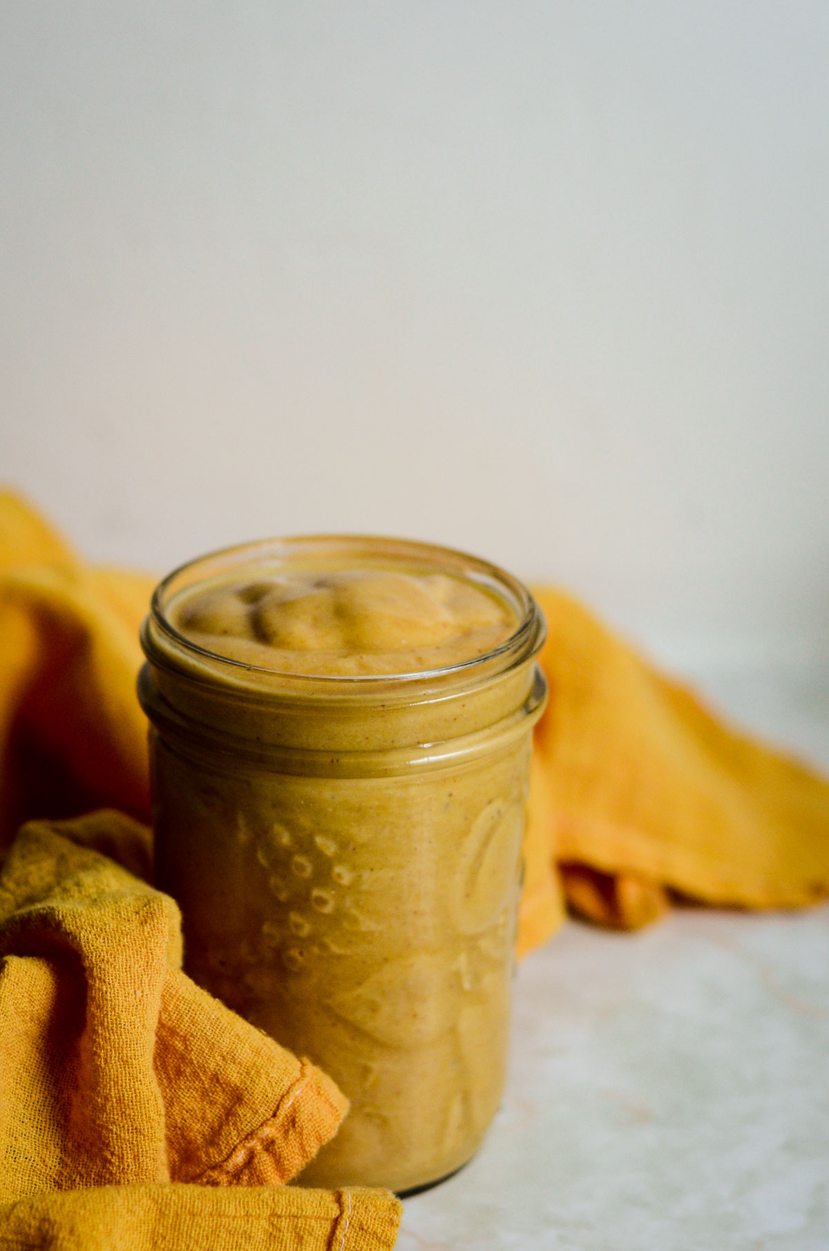 One quinoa smoothie with pineapple in a jar.