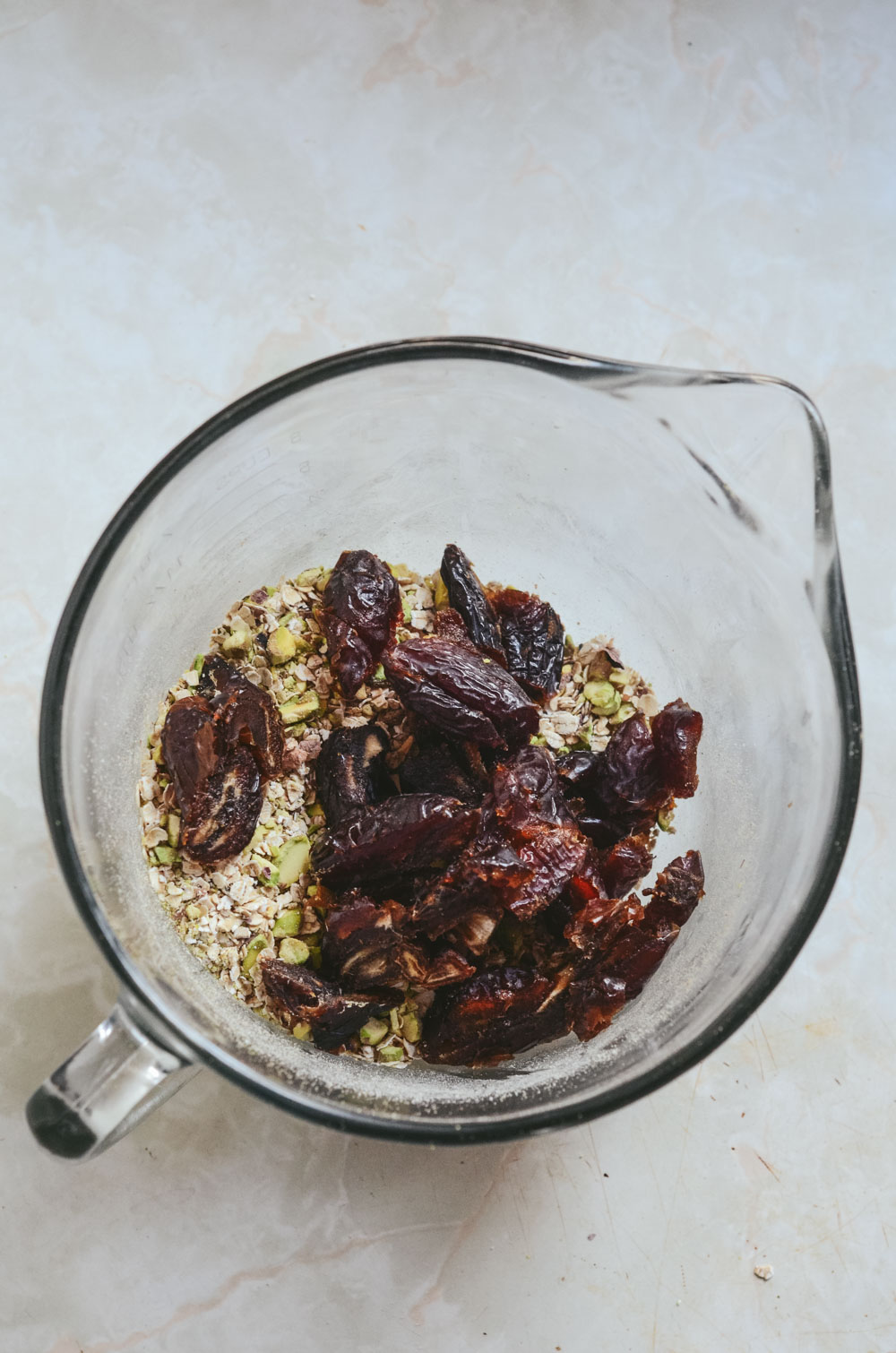 Dates, pistachios, oats, in mixing bowl.