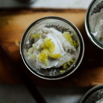Lemon zest on coconut cream on lemon chia pudding in a jar.
