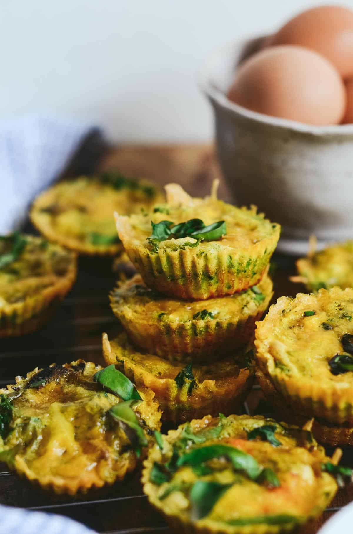 Egg bites stack on top of each other, with green spinach and kale.