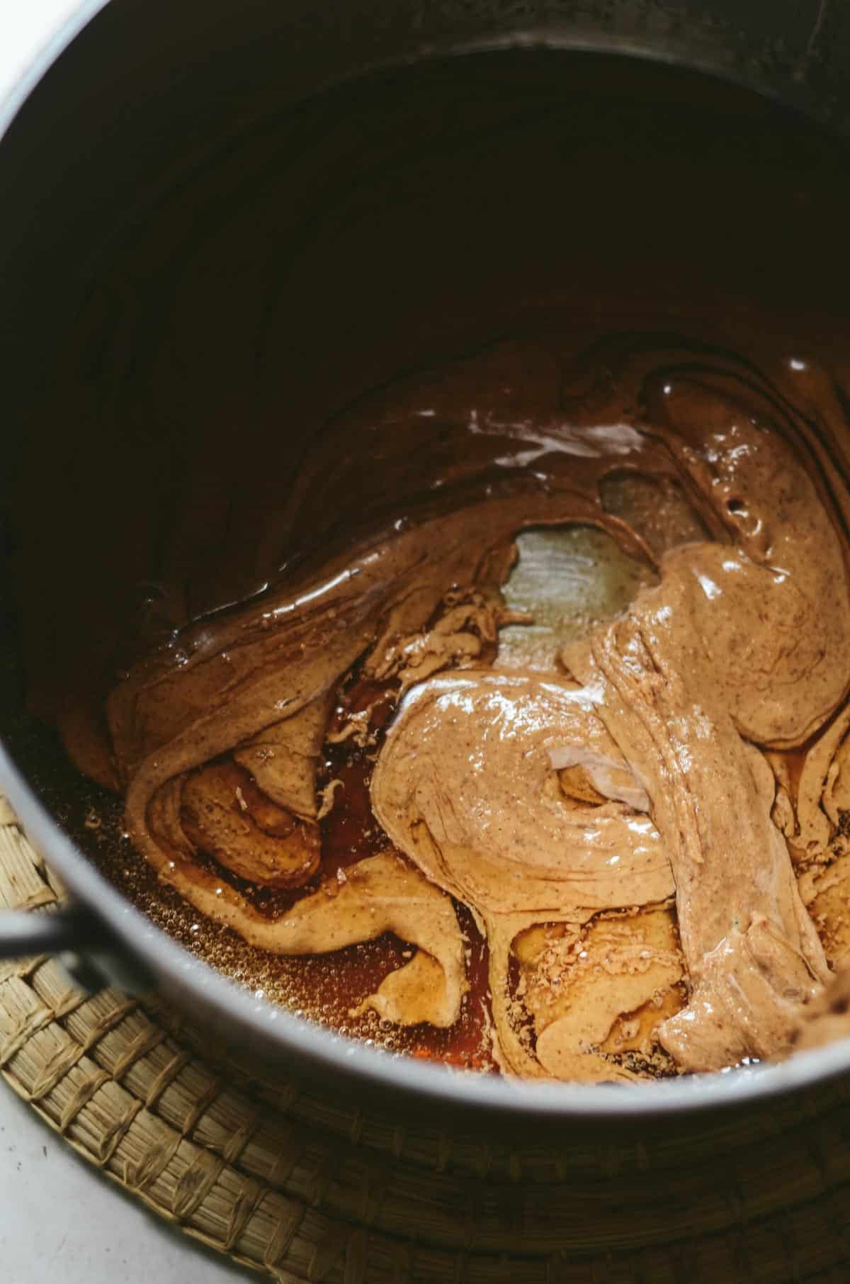 Maple syrup and almond butter in a pot.