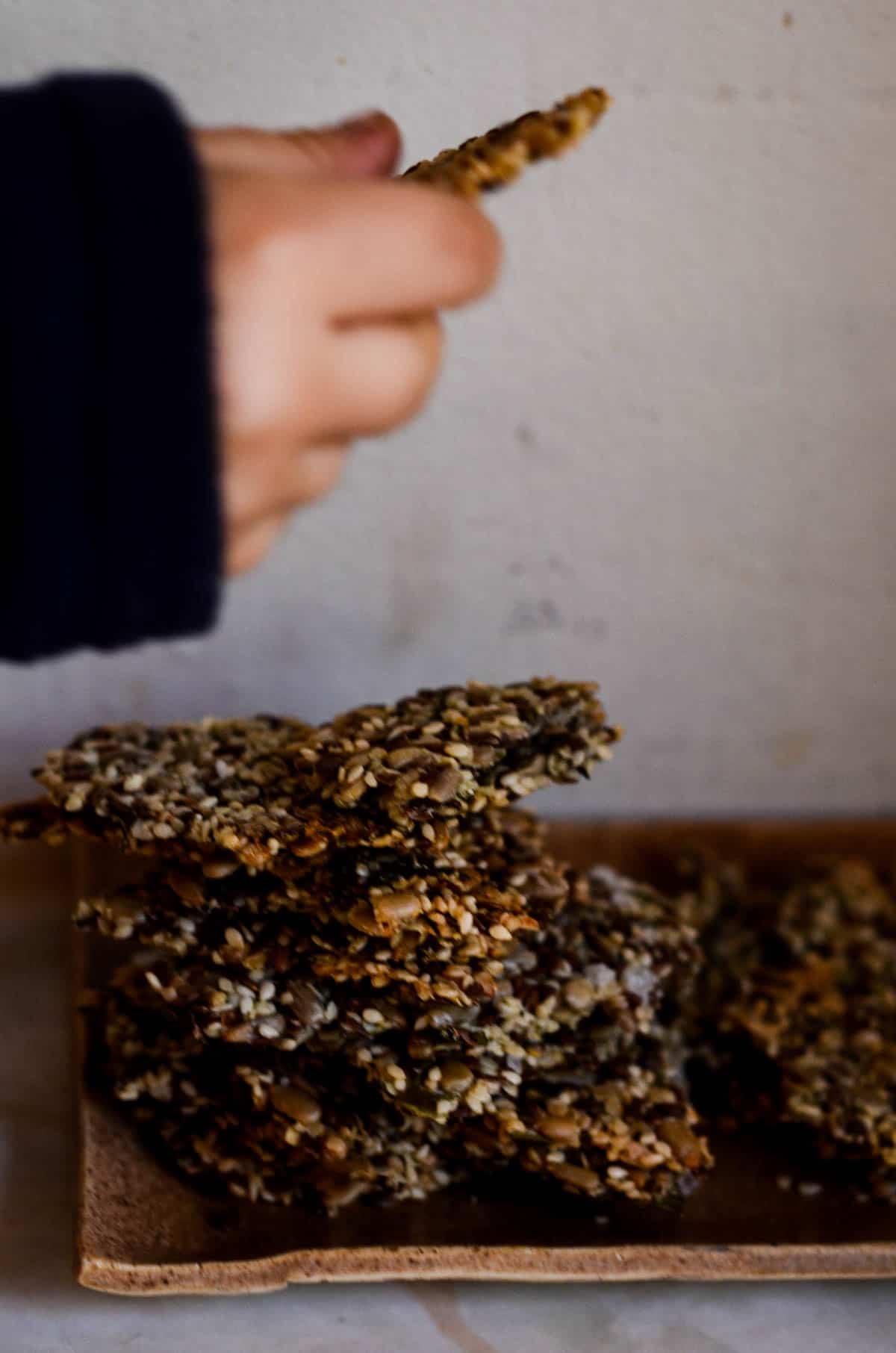 Reaching for a stack of multi seed crackers.