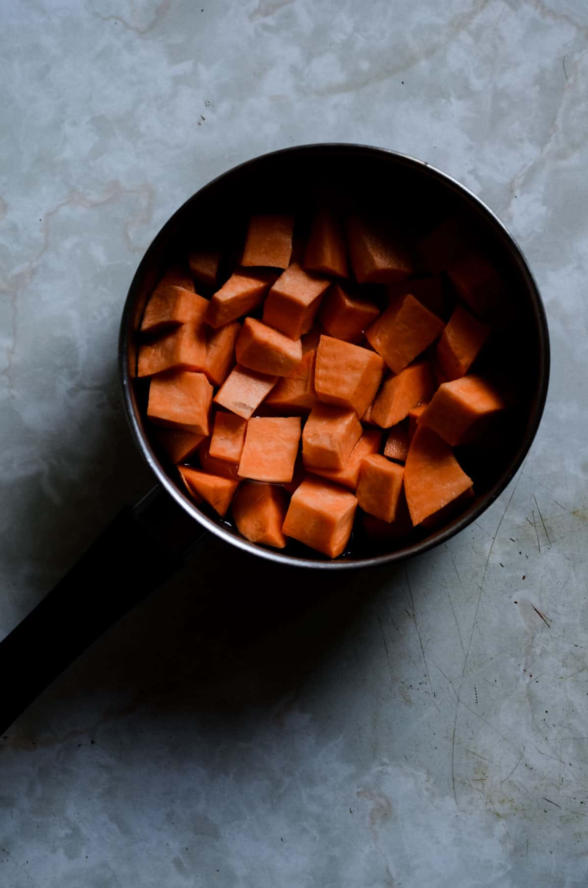 ½ inch chunks of sweet potato in a pot.