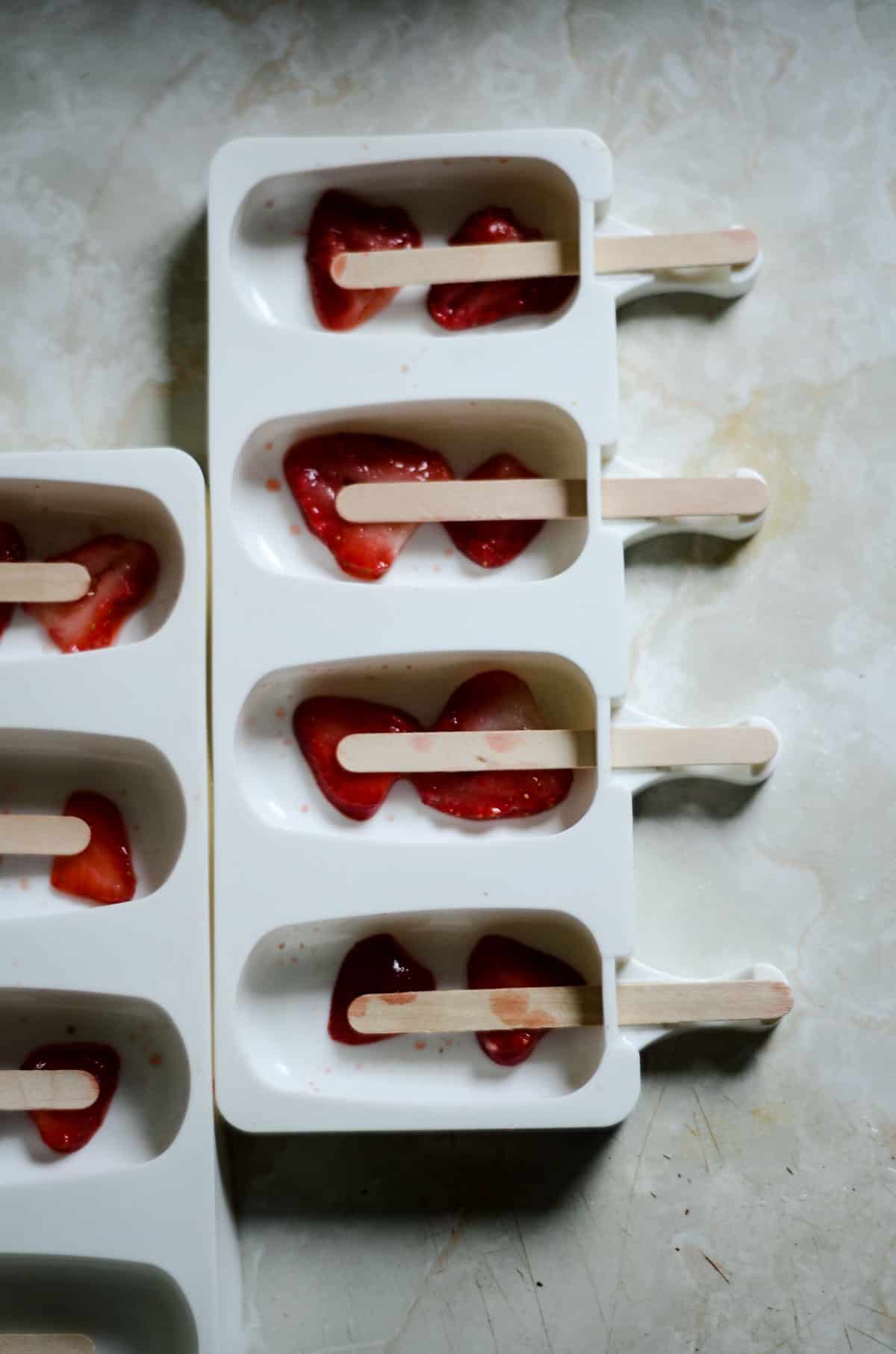 Strawberry Sliced in a silicone popsicle mold.