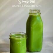Spinach smoothie, bright green in a jar and bottle on the counter for snack time.