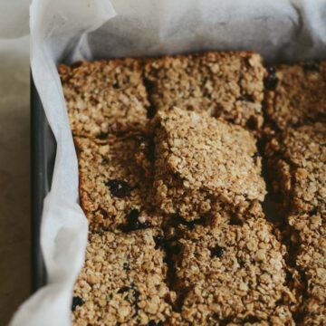 Chewy flapjacks cut into bars in a 8x8 pan.