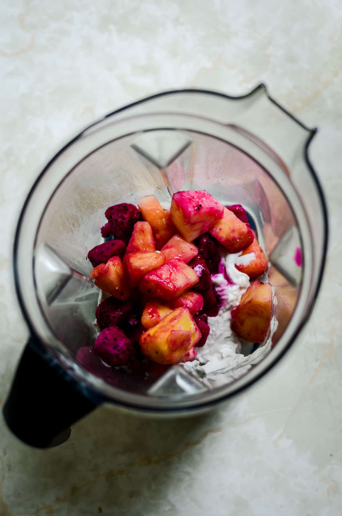 Dragon Fruit, pineapple, coconut milk, in the blender container.