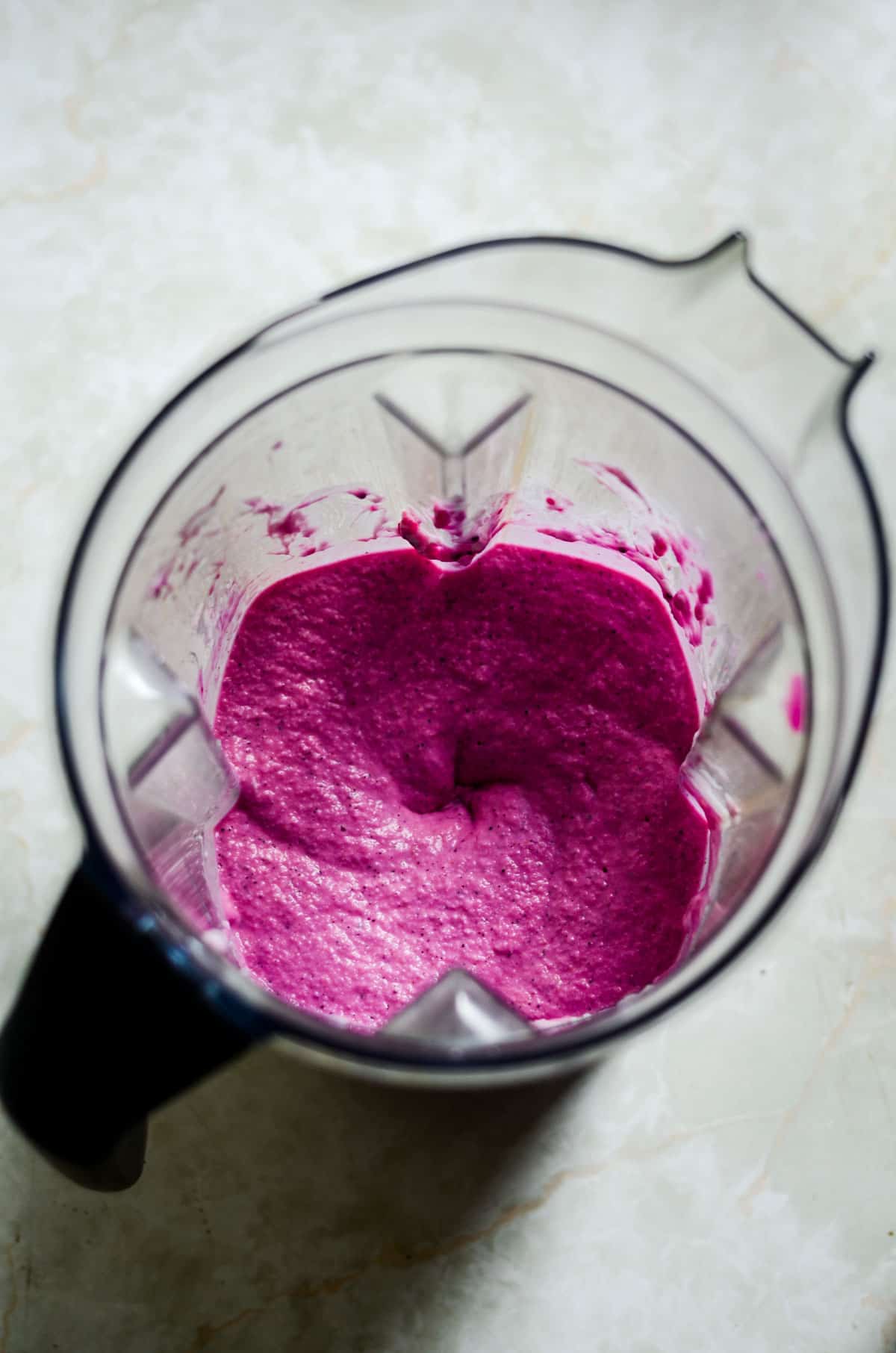 Bright pink pitaya mix in the blender for popsicles.