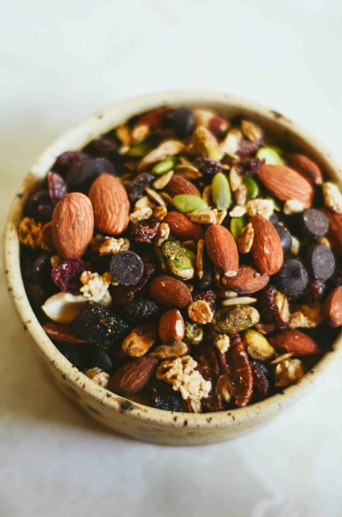 Trail mix with almonds, seeds, dried fruit, chocolate, for hiking.