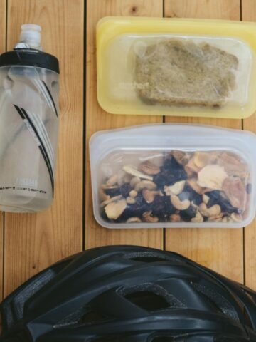 Water bottle, homemade trail mix, homemade baked snack, and helmet.