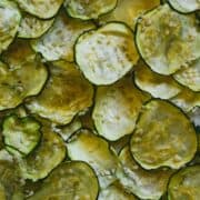 Dehydrated zucchini chips laying flat over lapping each other.