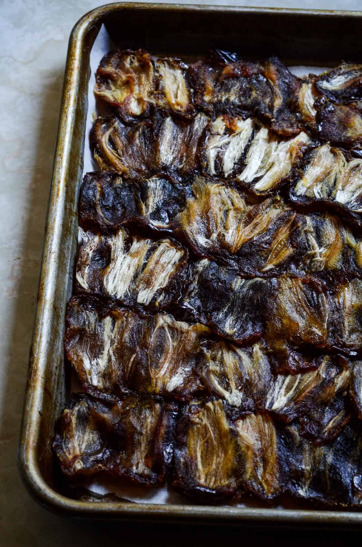 Medjool dates pitted and pressed into a small baking pan.