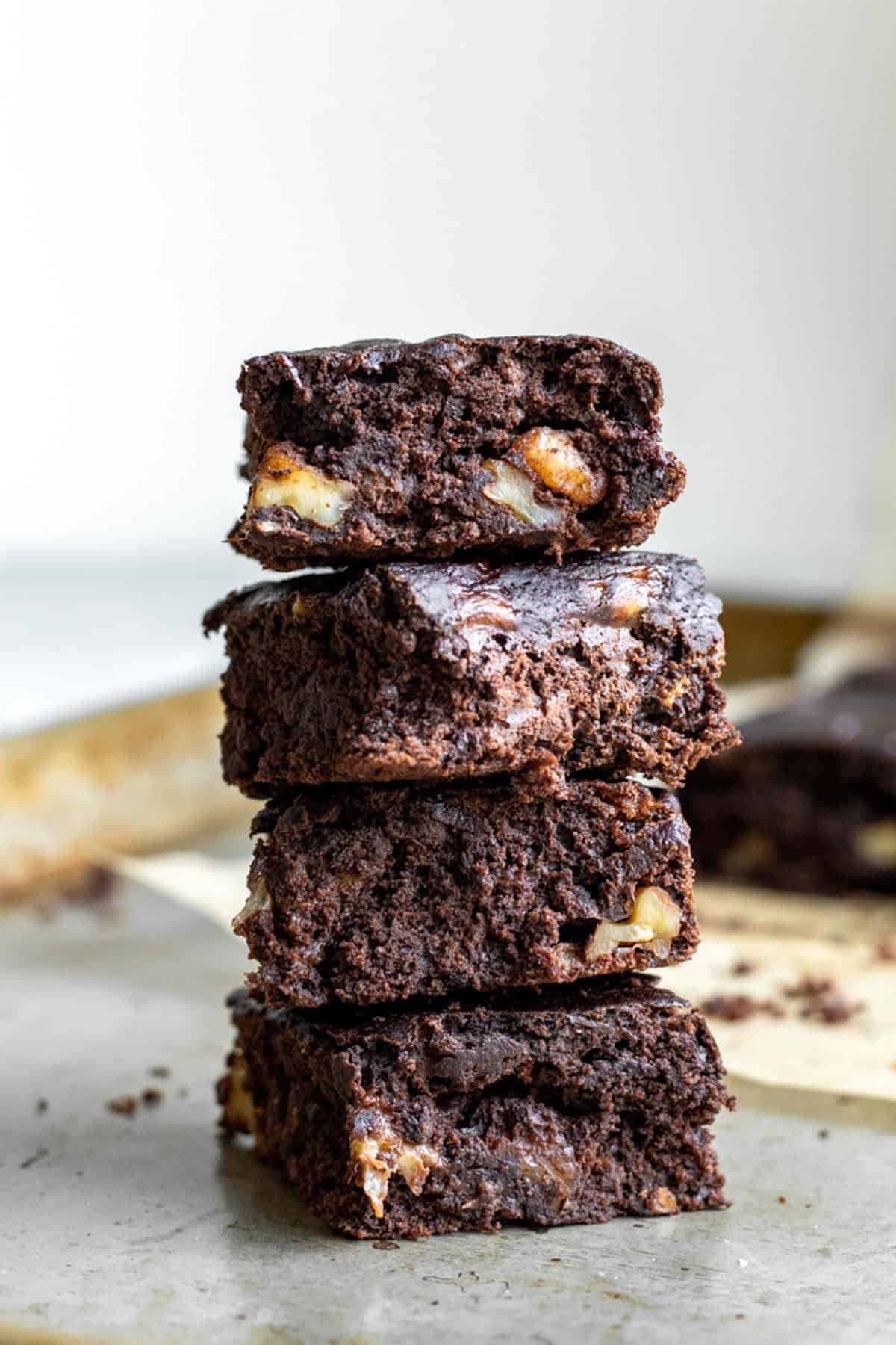Brownies stacked on top of one another, with chunks of banana inside.