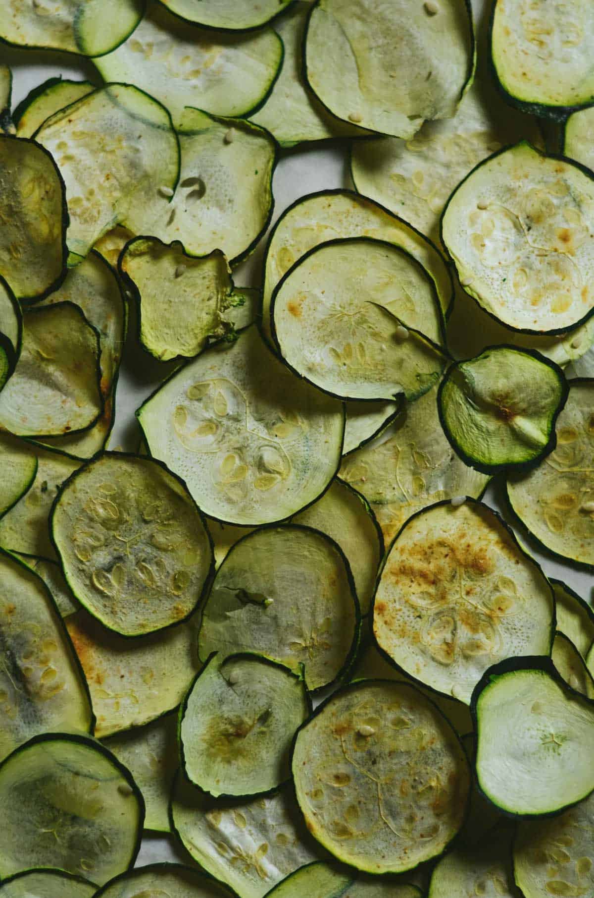 Dehydrated zucchini chips laying flat over lapping each other