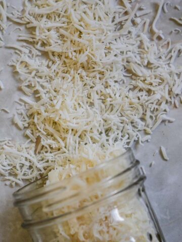Pieces of long shredded coconut coming out of a jar.