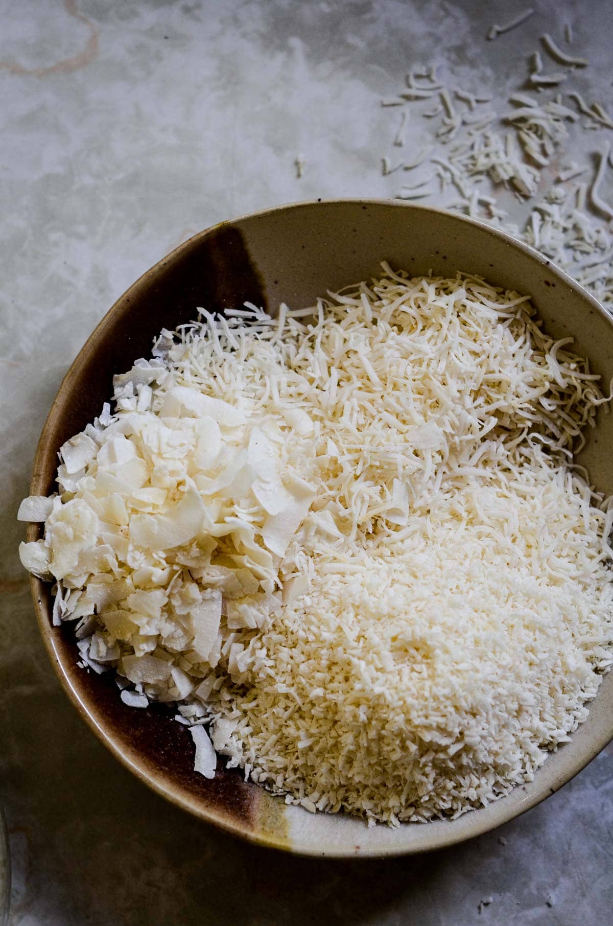 Shredded coconut, flaked coconut, and desiccated coconut in a bowl.