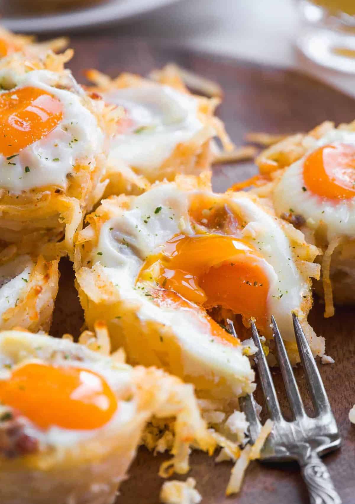 Yellow runny egg yolk baked into a hash brown muffin.