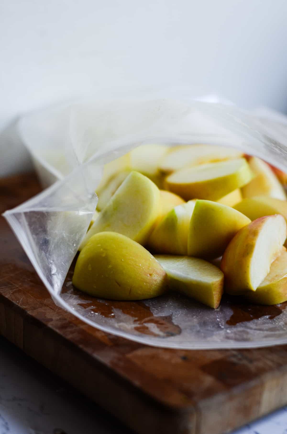 Fresh apples cut up in a freezer bag.