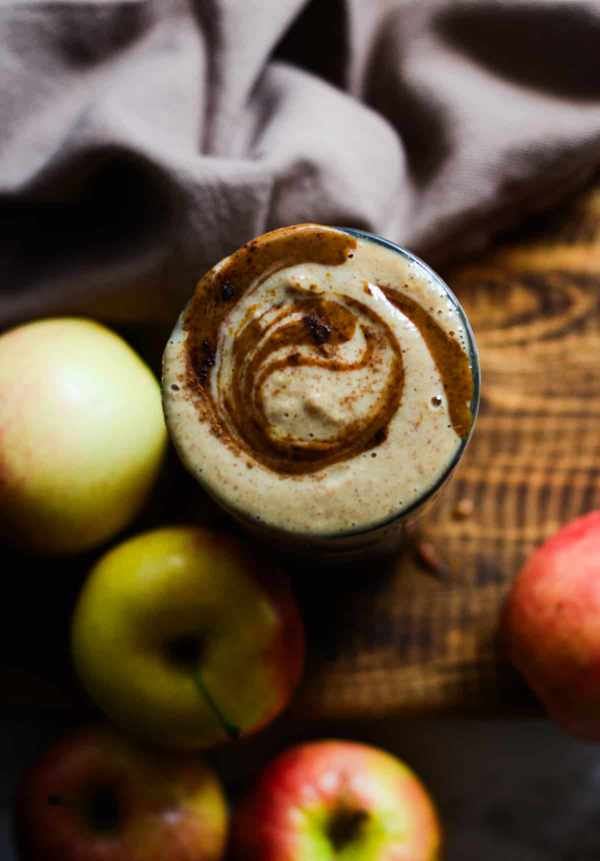 A creamy apple smoothie with almond butter on top
