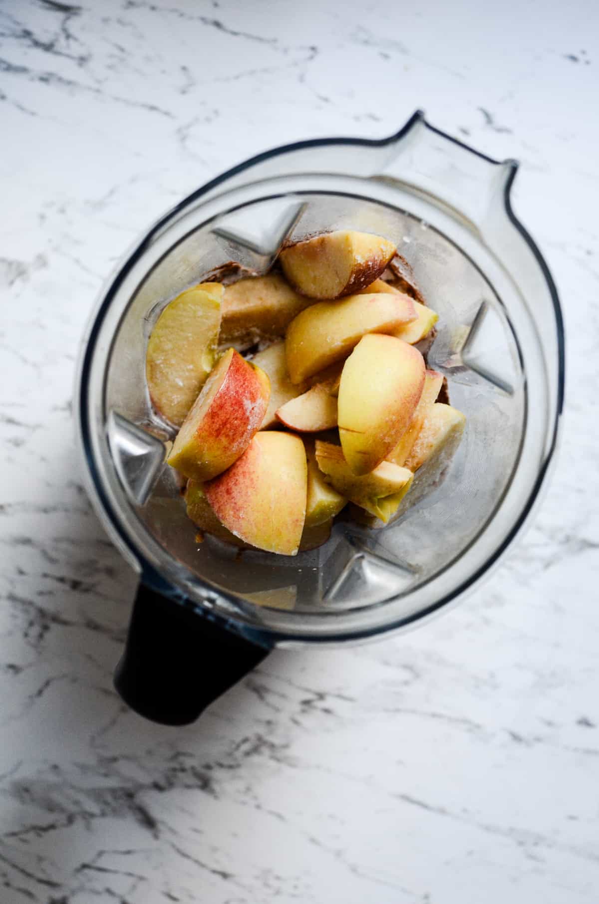 Frozen apples in the blender for a smoothie.