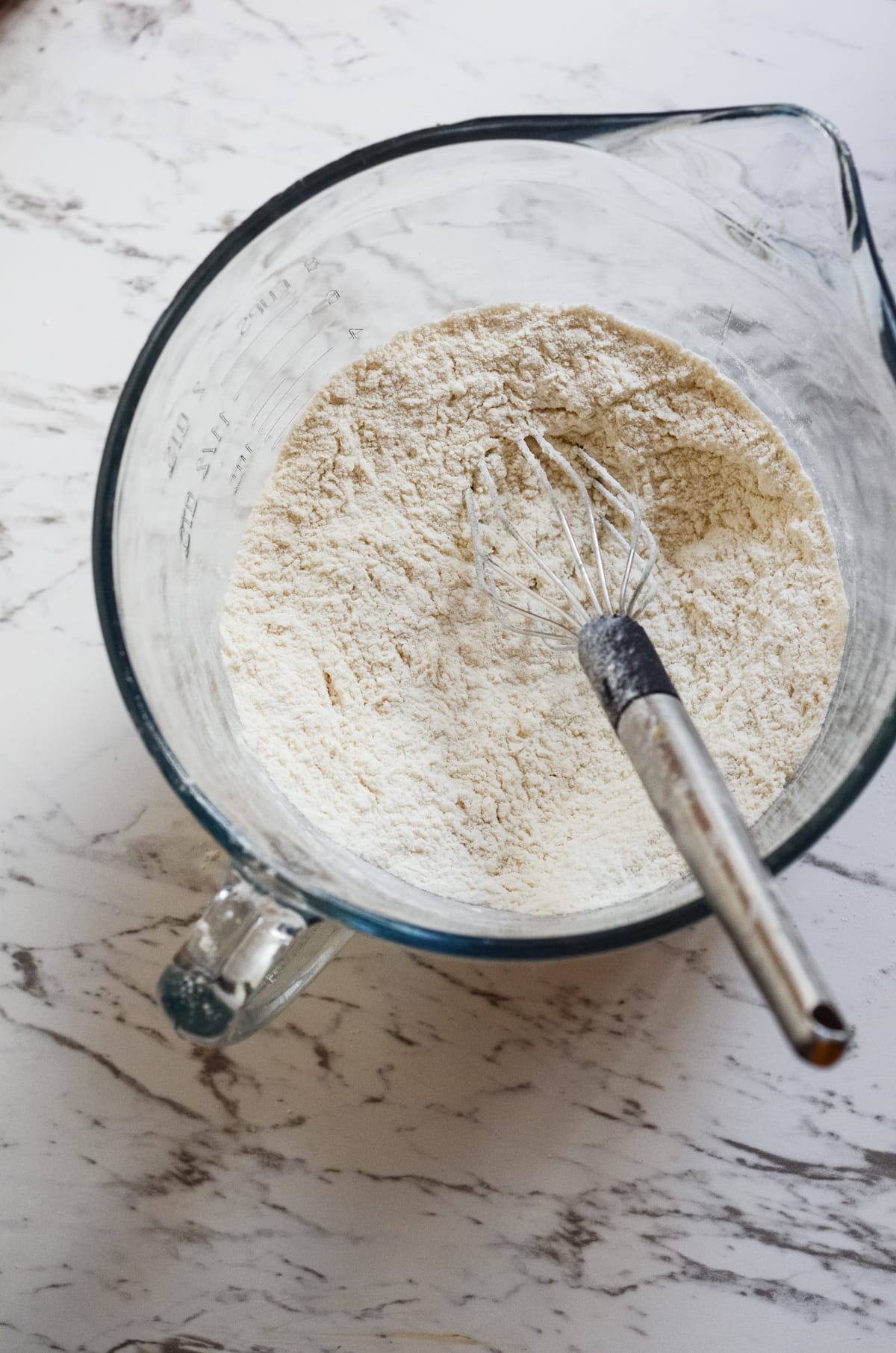 Flour being whisked in a bowl.