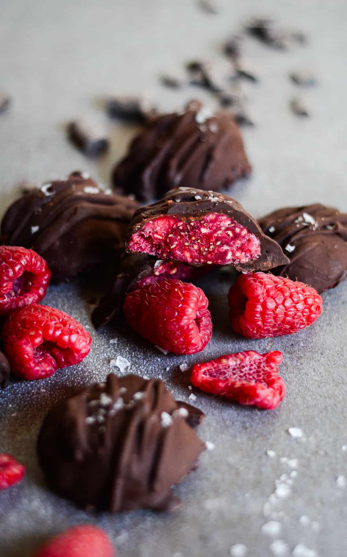 Raspberry chia jam covered in chocolate on a platter with raspberries.
