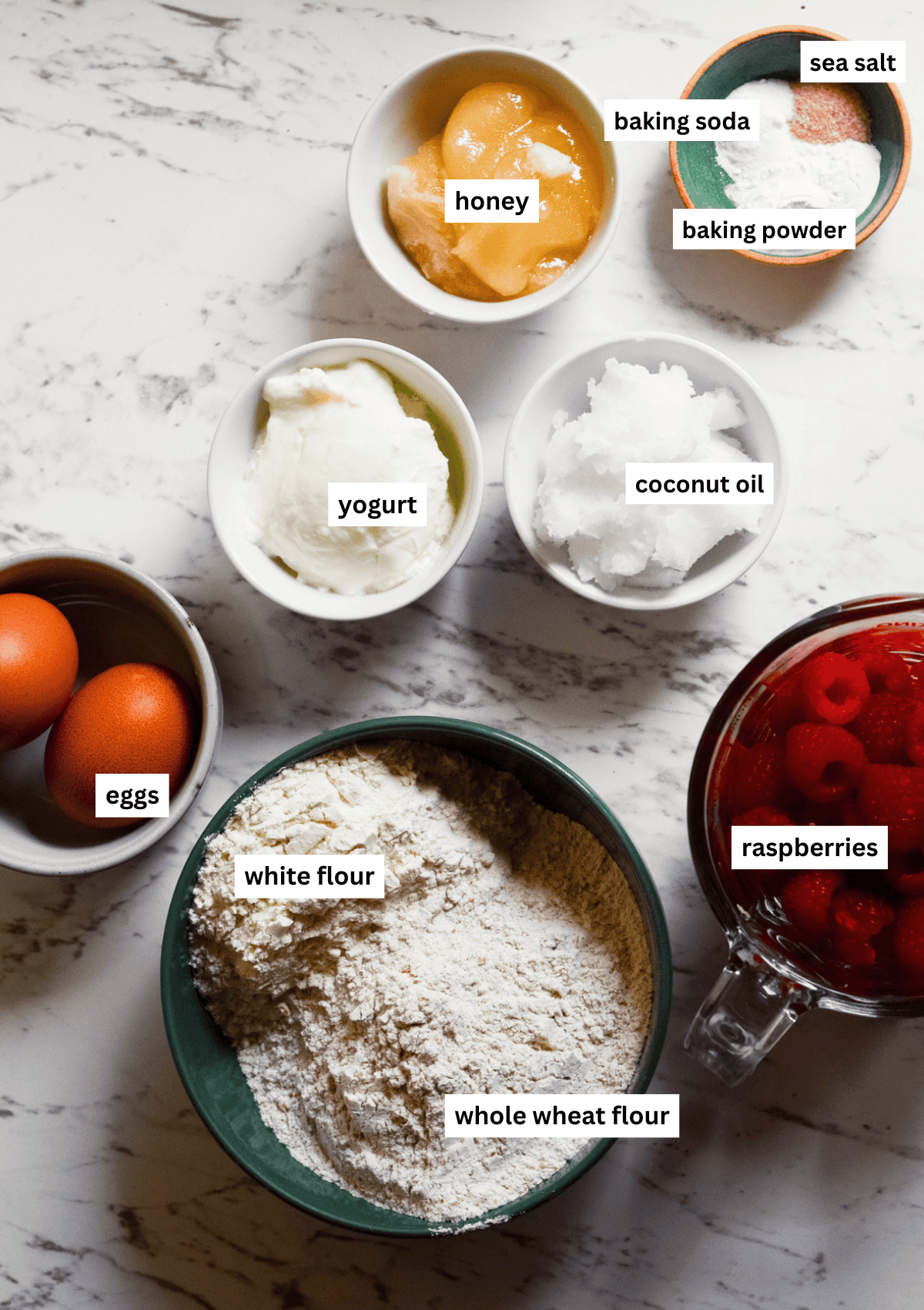 Labelled ingredients for yogurt raspberry popsicles all on the counter.