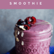 Pin graphic of a purple cherry and blueberry smoothie with halved cherry and oats on top.