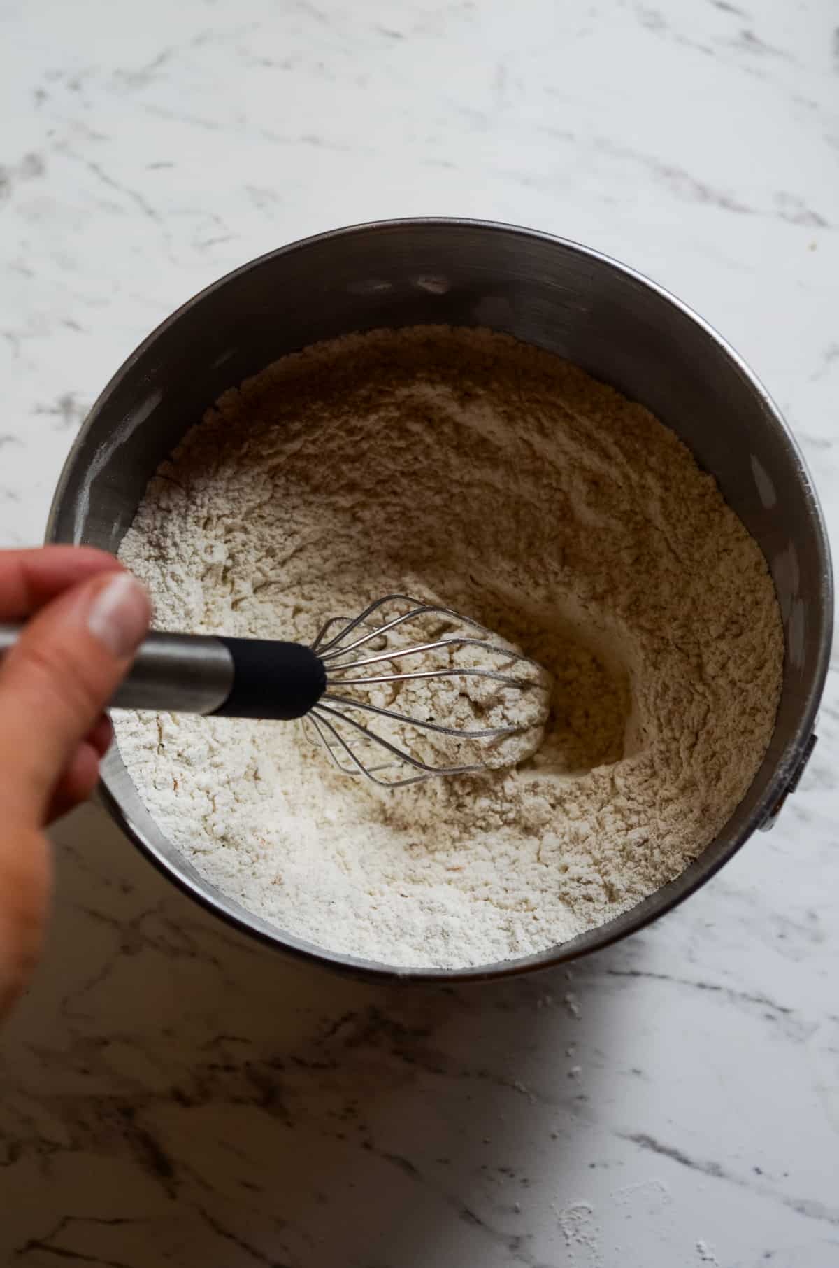Whisking together flour and dry ingredients for muffins.
