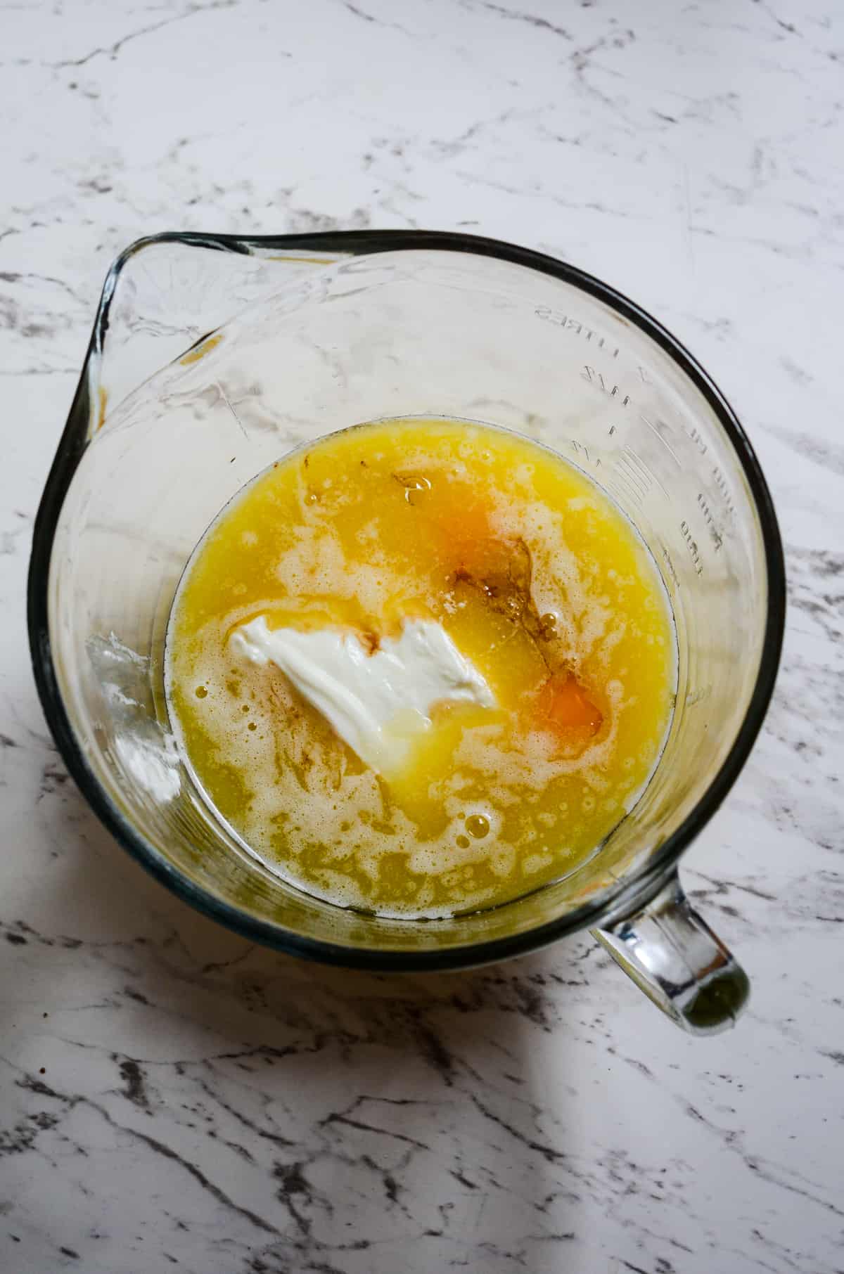 Eggs, yogurt, oil, in a medium mixing bowl.