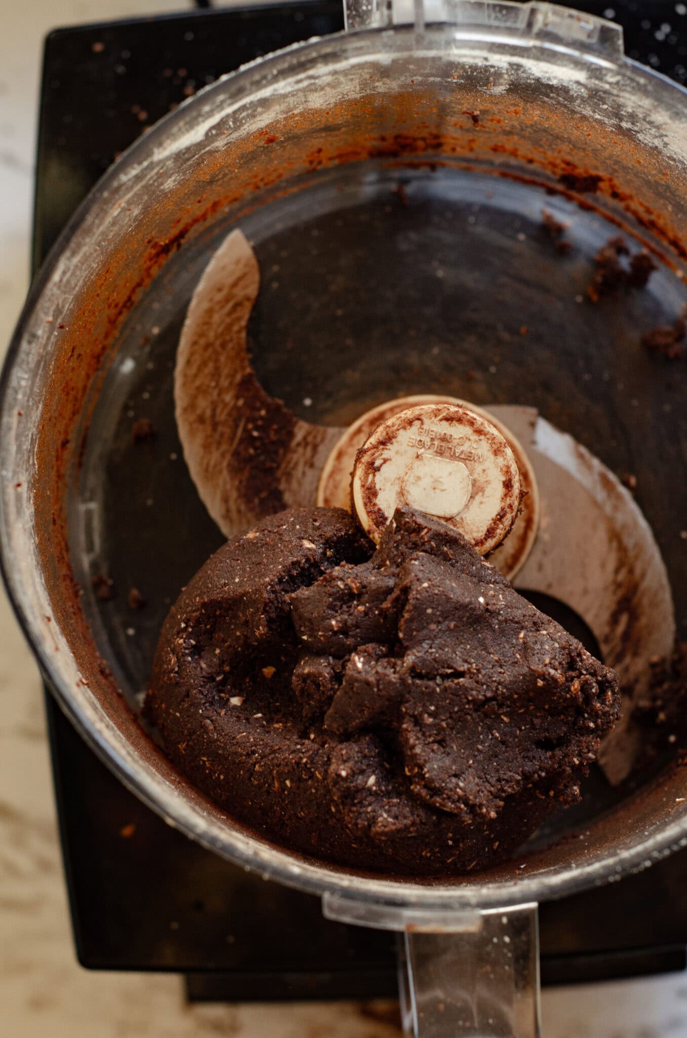 Banana chocolate dough in a food processor ready to form into energy bites.