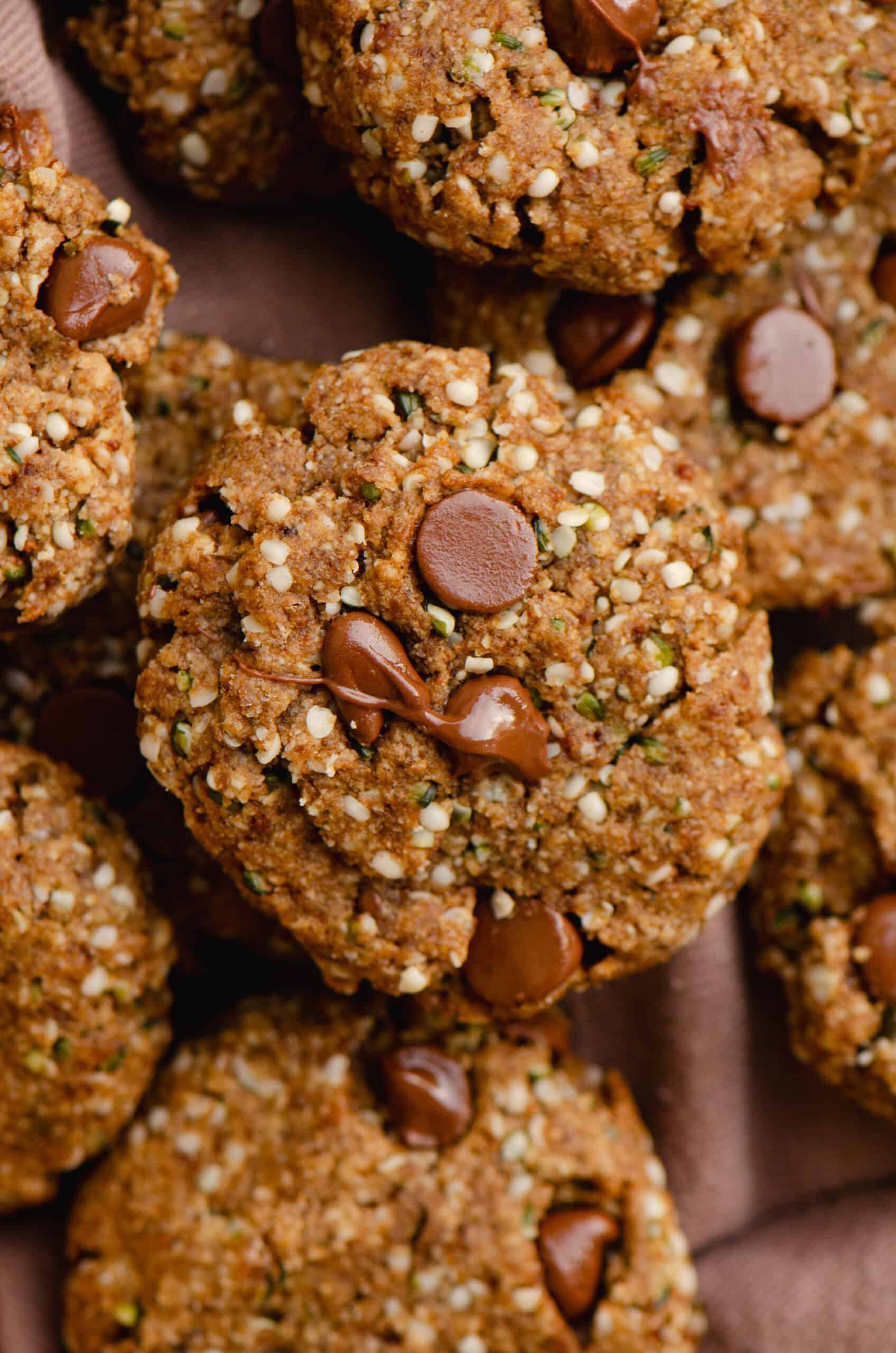 A pile of cookies with chocolate chips on top with hemp hearts.