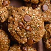 A pile of cookies with melted chocolate chips on top with hemp hearts.