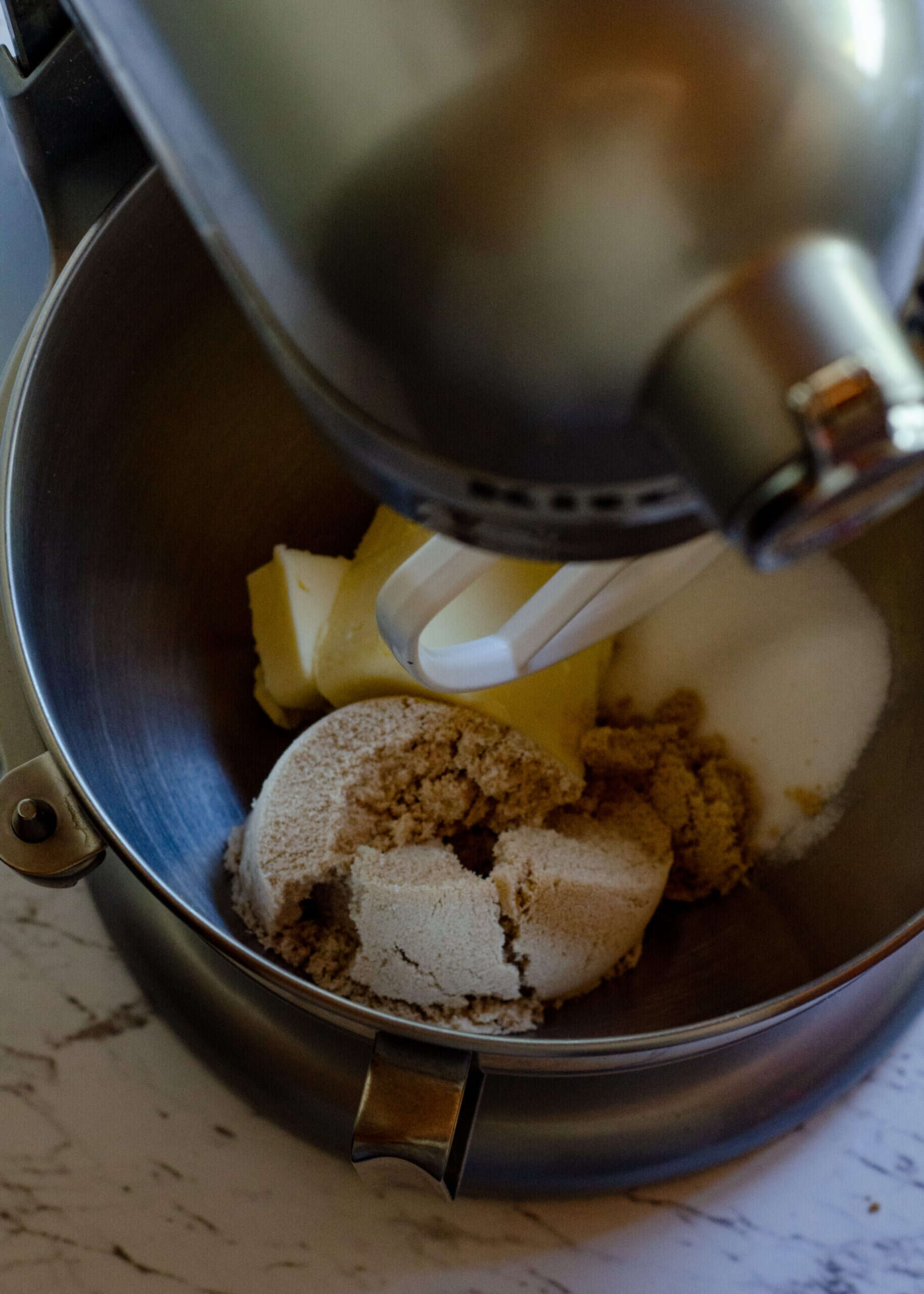 Soft butter and golden brown sugar, and white sugar in a kitchen aid mixer. 