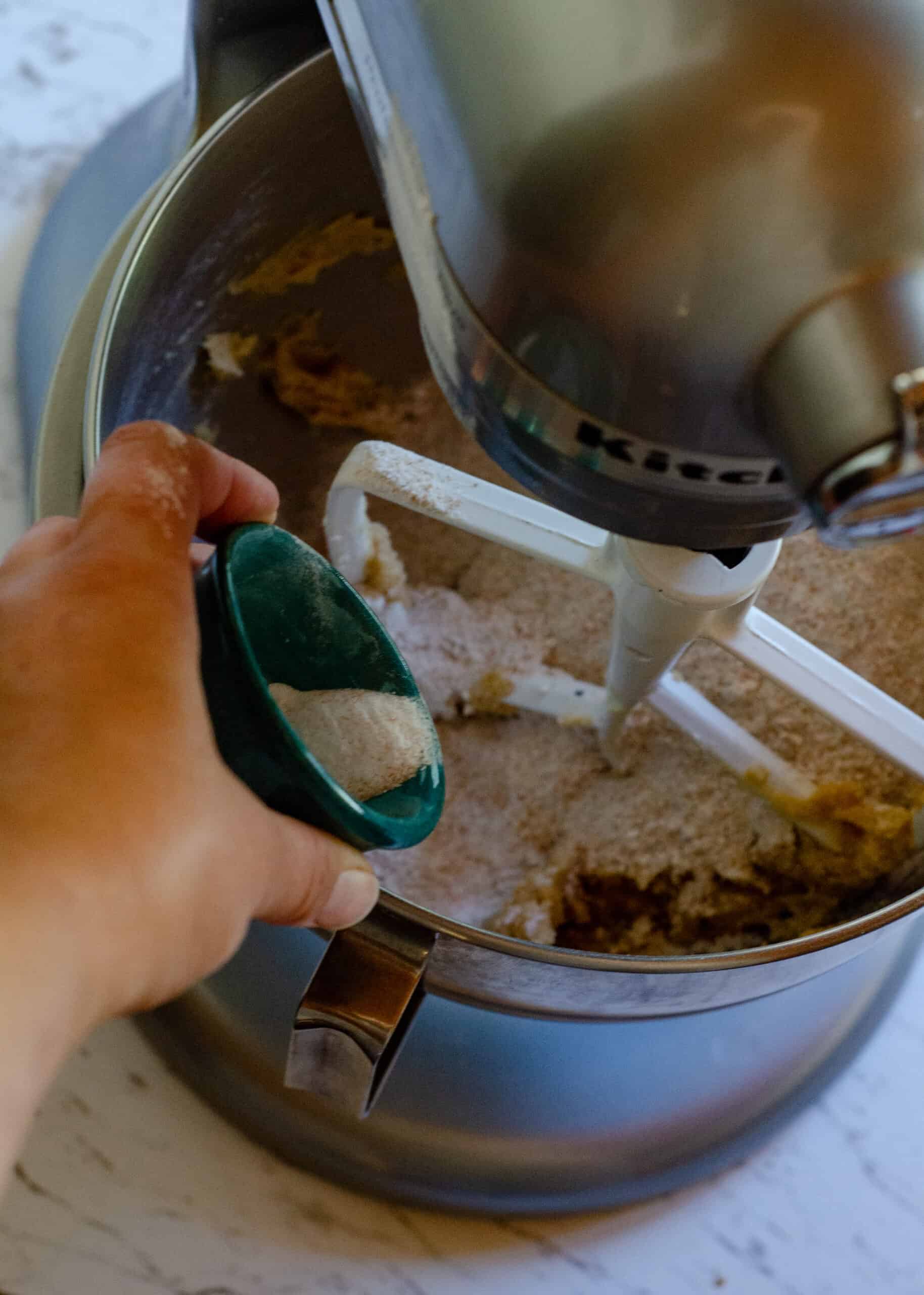 Adding the flour and baking soda, and salt to the chocolate chip cookie dough.