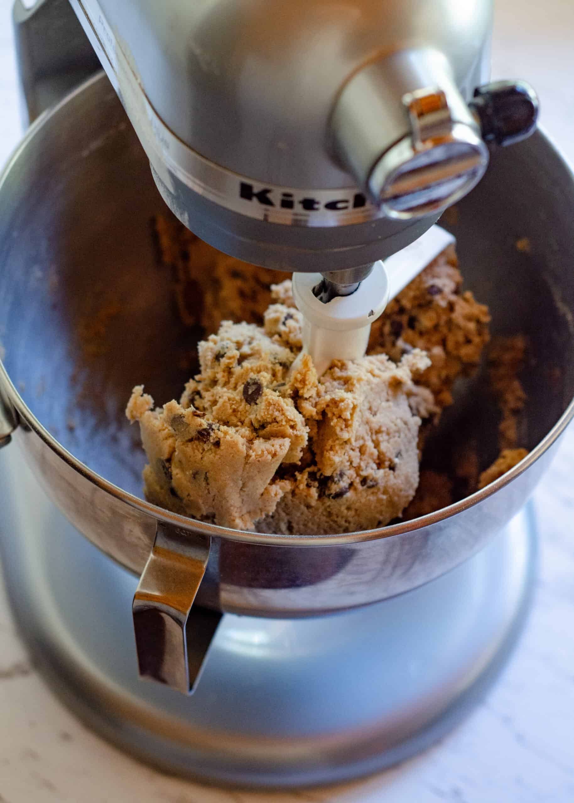 Cookie dough with chocolate chips on the kitchen aid paddle.