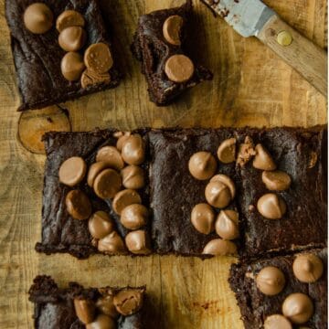 A gluten free brownie made with dates and cocoa powder with chocolate chips on top.