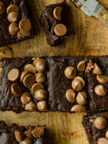 A gluten free brownie made with dates and cocoa powder with chocolate chips on top.