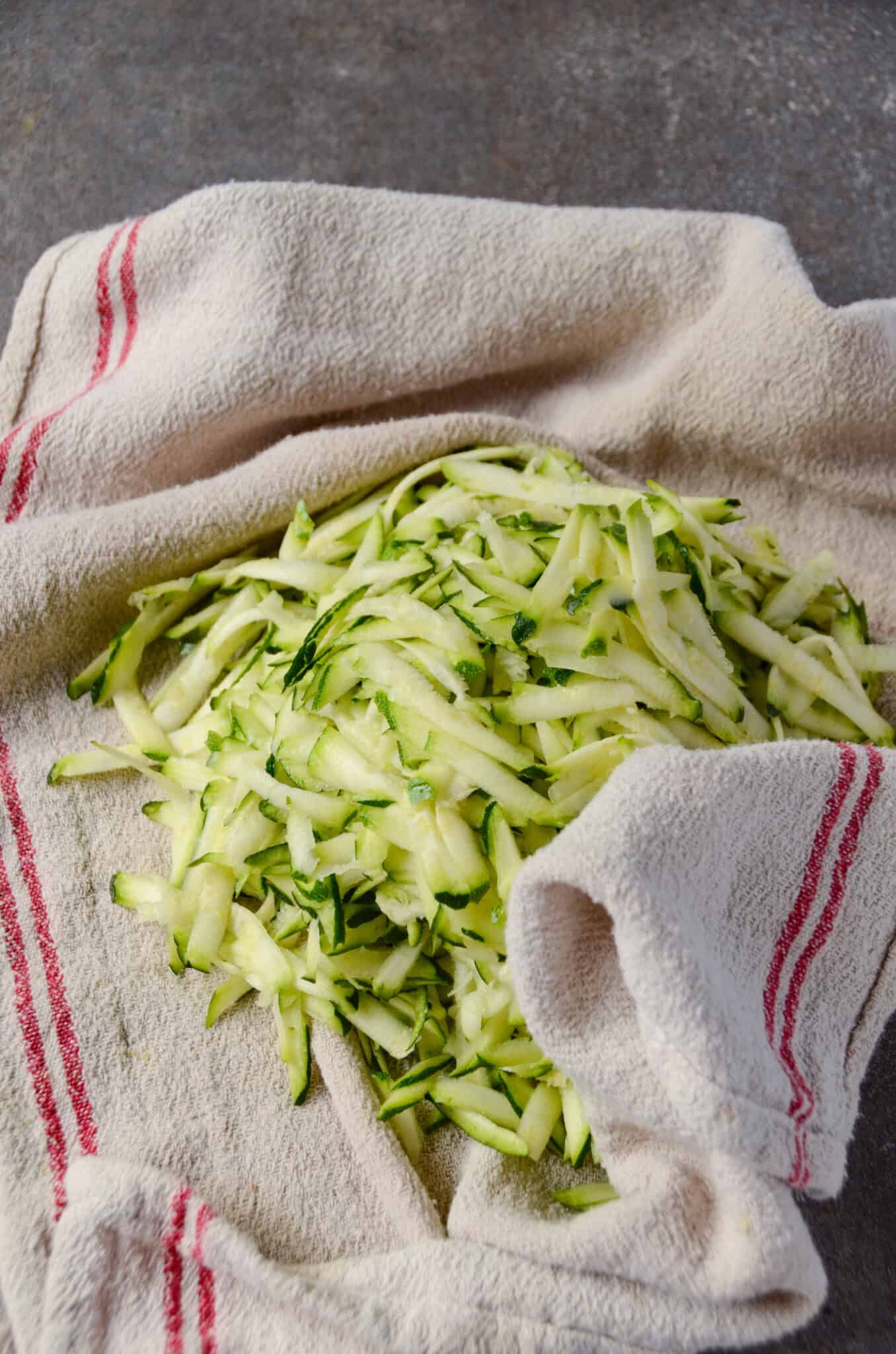Grated zucchini on a tea towel.