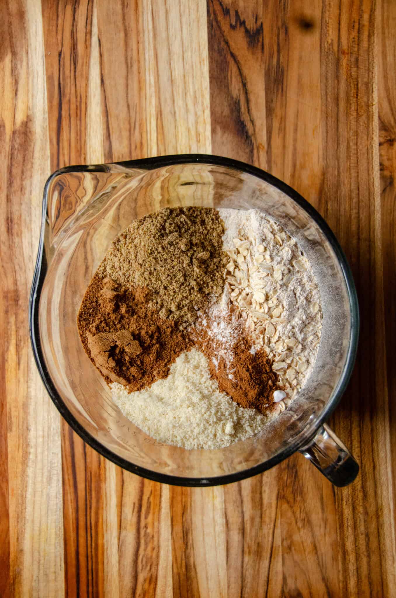 Dry ingredients for muffins in a glass mixing bowl.