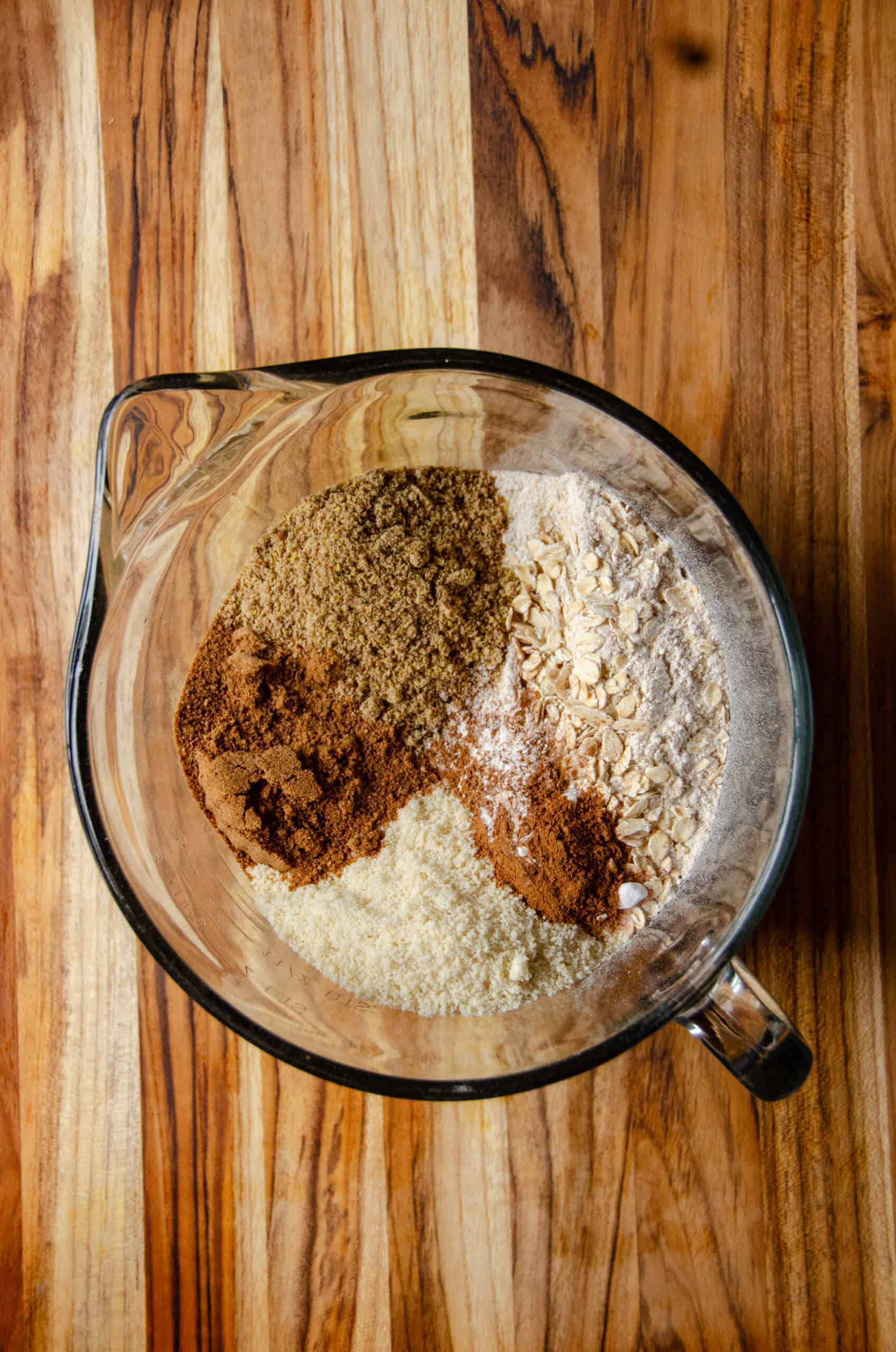 Dry ingredients for muffins in a glass mixing bowl.