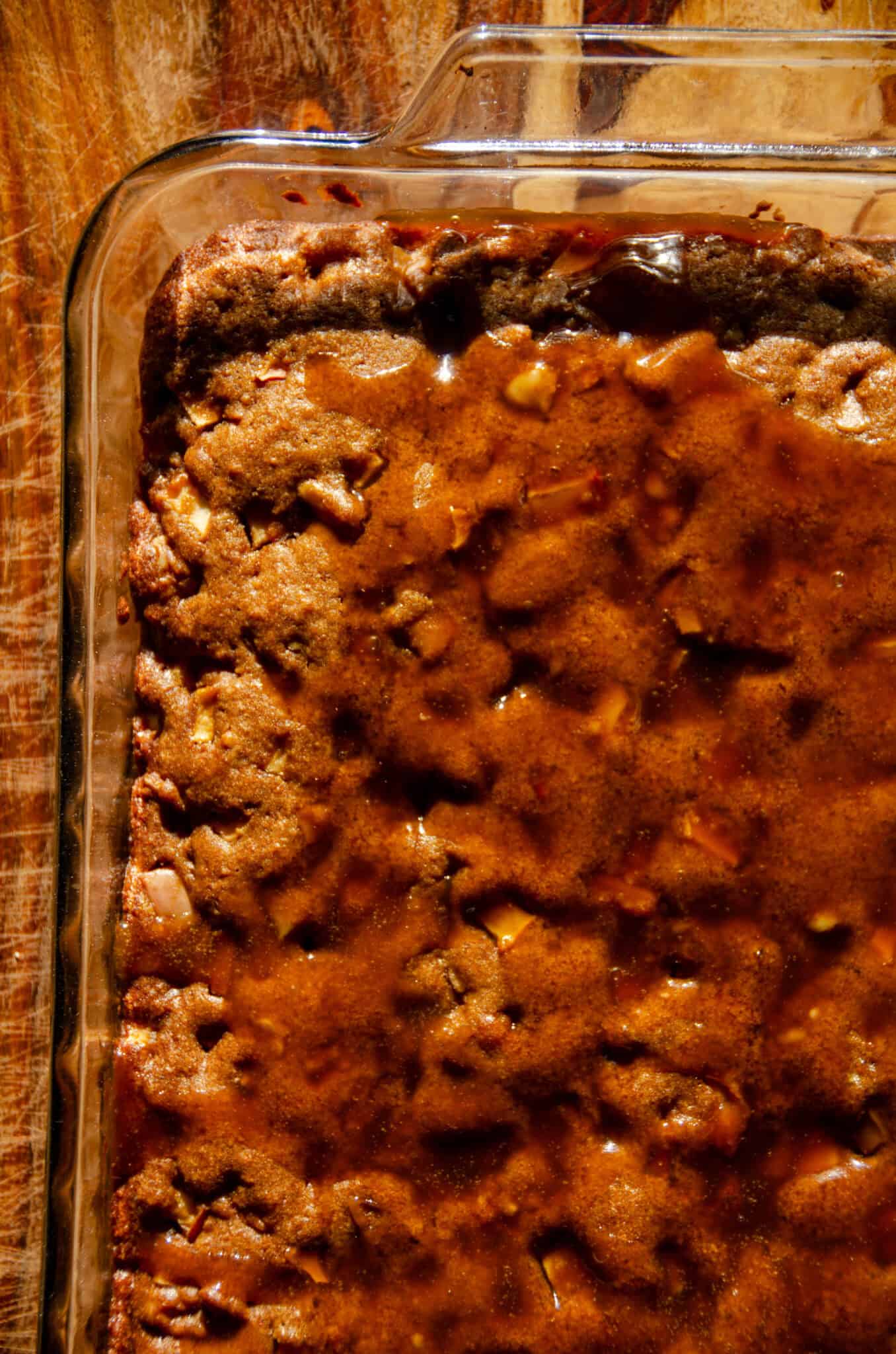 A brown glazed apple snack cake in a sheet pan.
